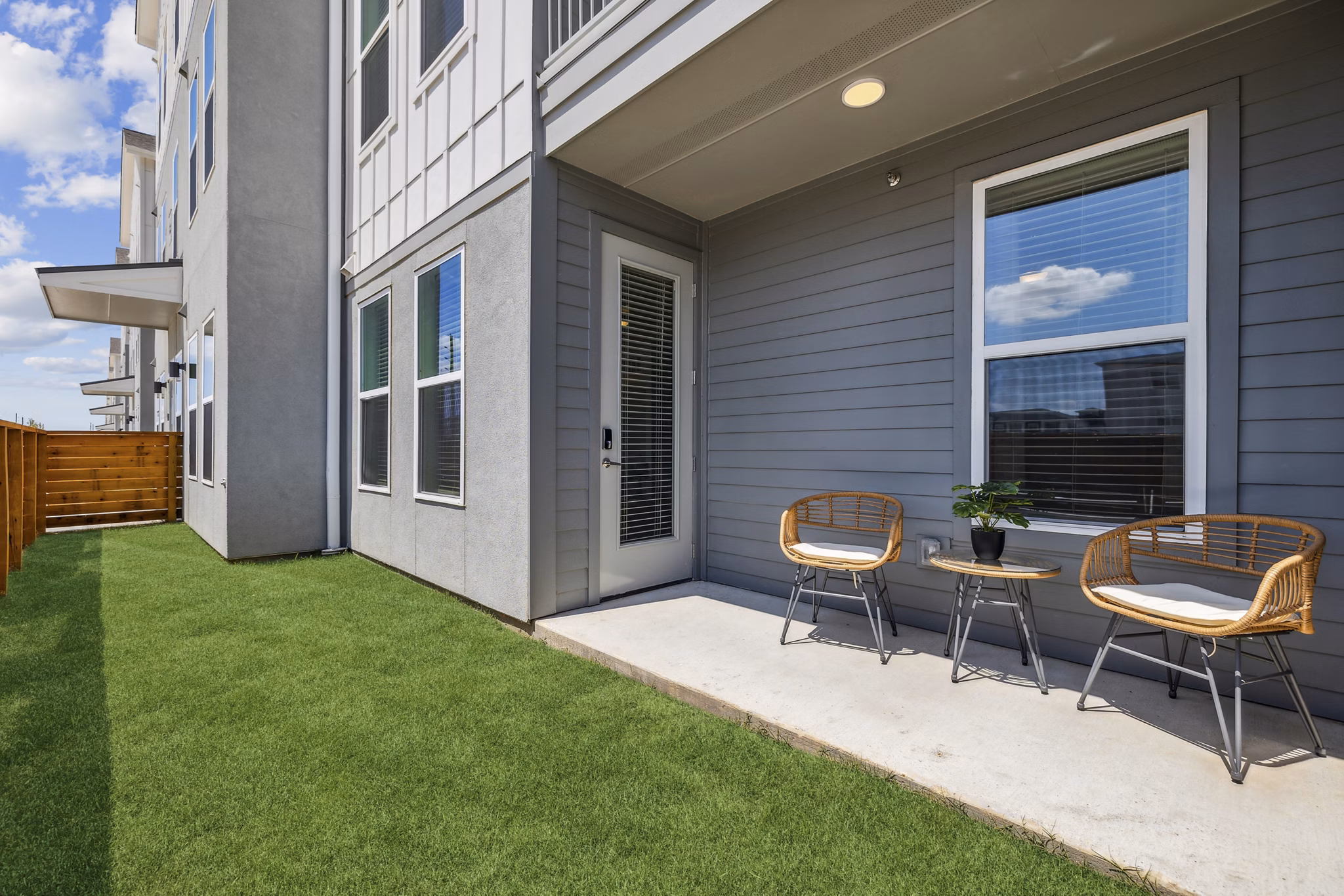 Rooftop patio with modern seating at Alta Grandway Apartments, offering luxury outdoor living space in a serene setting