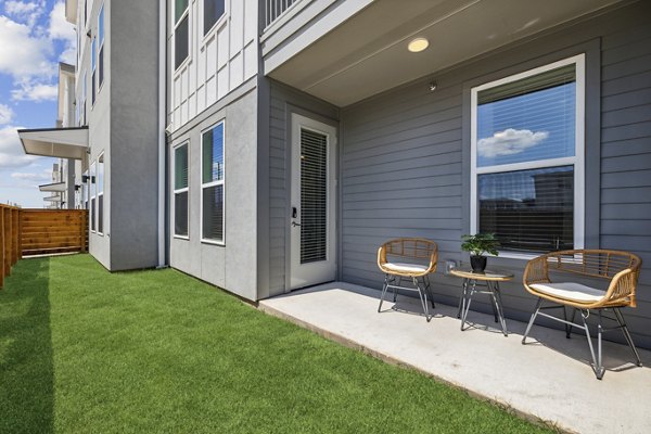 Rooftop patio with modern seating at Alta Grandway Apartments, offering luxury outdoor living space in a serene setting