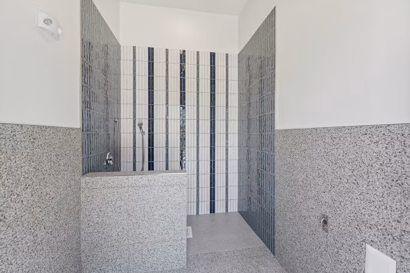 Dog wash station with easy-access tub at Alta Grandway Apartments, catering to pet-friendly living