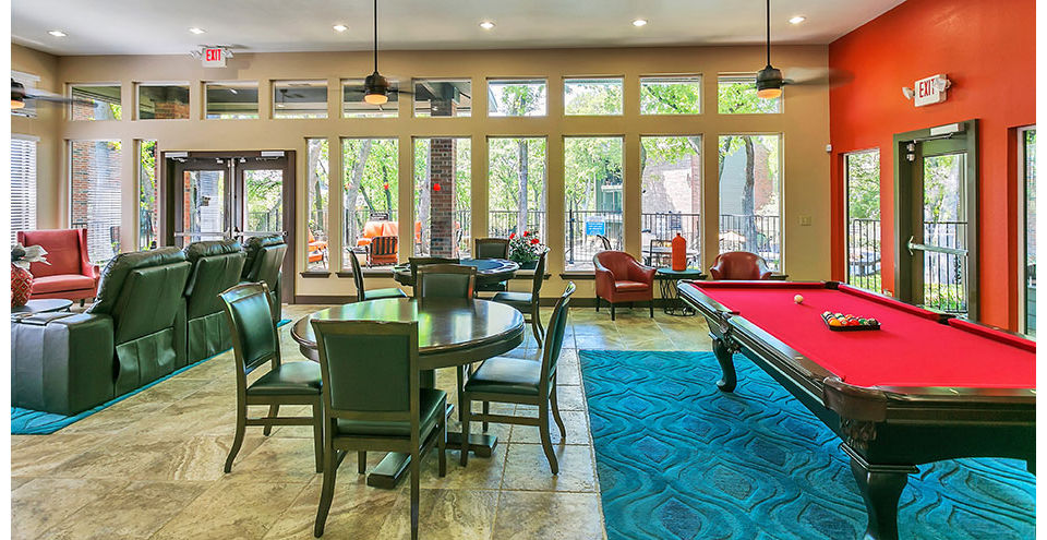 Clubhouse with cozy seating areas and community space at Wood Hollow Apartments