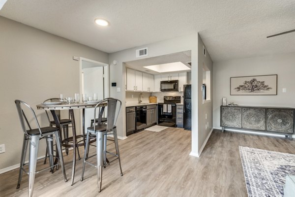 Dining area with modern furnishings and elegant lighting in Wood Hollow Apartments