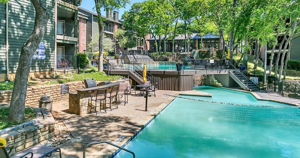 Pool with resort-style design at Bay Court at Wood Hollow Apartments offers a luxury living experience