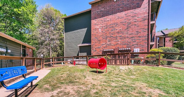 Spacious dog park with agility equipment at Wood Hollow Apartments