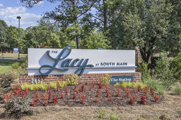 Signage displaying The Lacy at South Main Apartments entrance, showcasing luxury living options in an upscale community