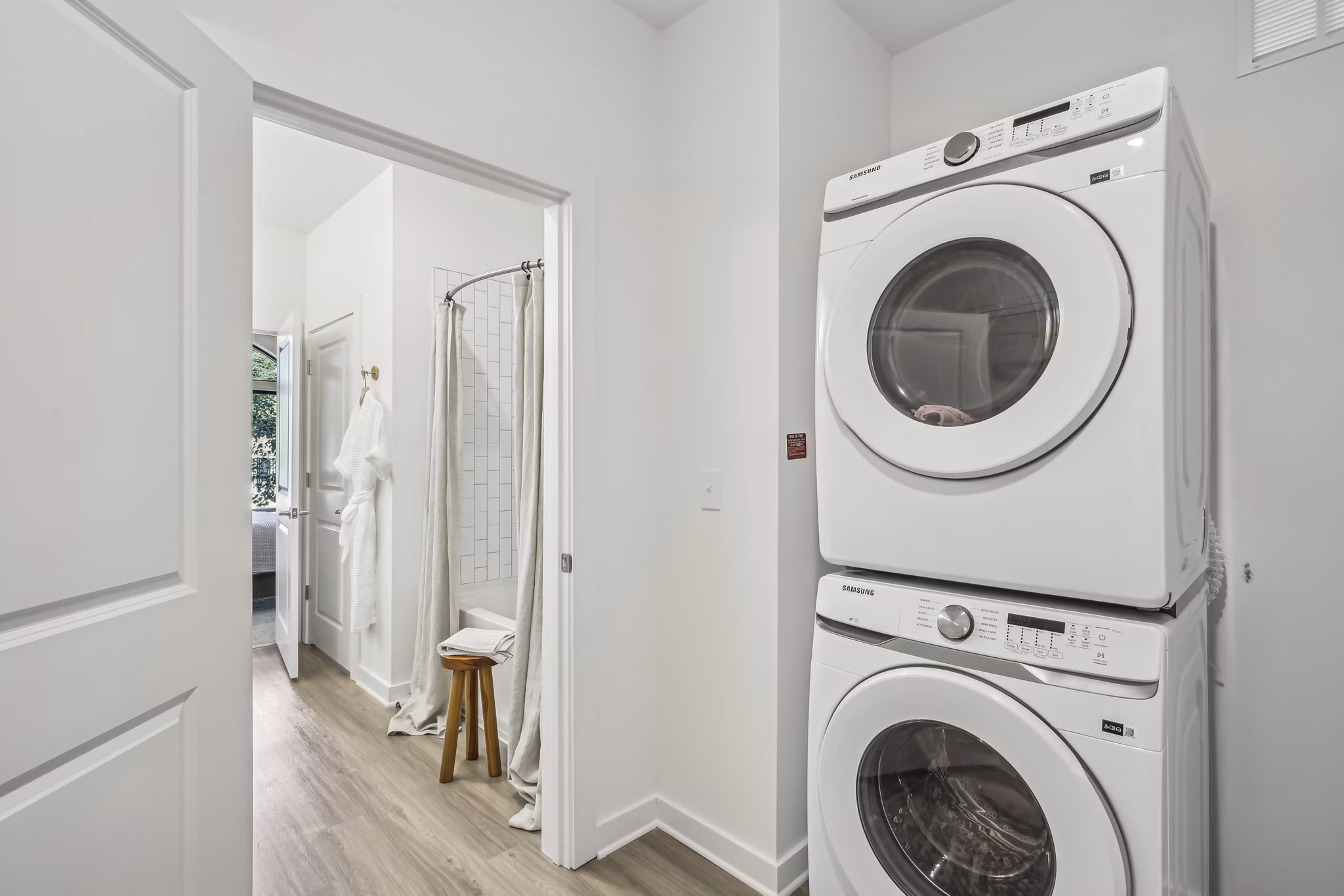 Laundry room with modern appliances at The Lacy at South Main Apartments, offering convenient in-unit laundry facilities