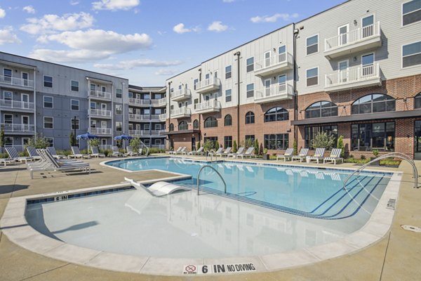 Inviting outdoor pool at The Lacy at South Main Apartments offering luxurious relaxation