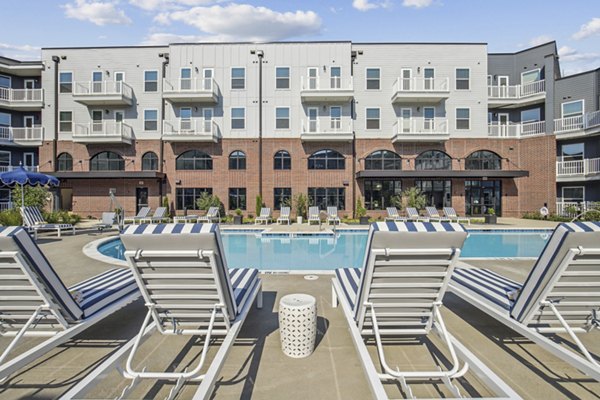 Serene outdoor pool area with lounge seating at The Lacy at South Main Apartments in Houston, ideal for relaxation and leisure