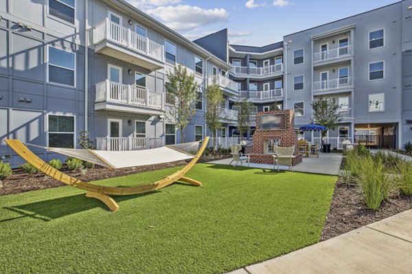 Courtyard with landscaped gardens at The Lacy at South Main Apartments, offering a peaceful retreat in the heart of the city