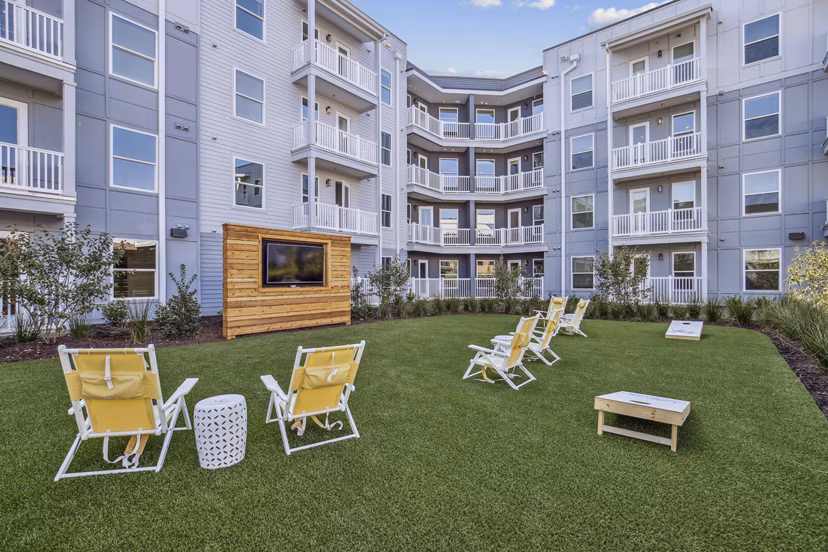 Recreational area with lounge seating and game tables at The Lacy at South Main Apartments