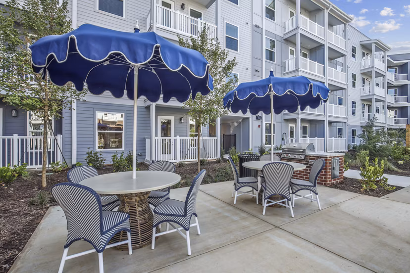 Outdoor grill area with modern seating at The Lacy at South Main Apartments, a luxury community offering premier amenities and stylish living spaces