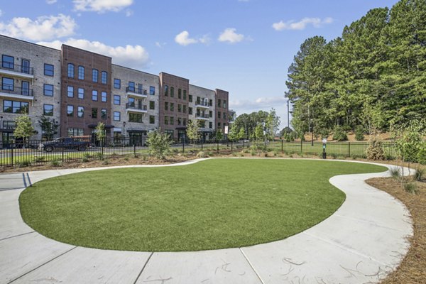 Modern playground with colorful slides and climbing structures at The Lacy at South Main Apartments, ideal for family recreation and outdoor fun