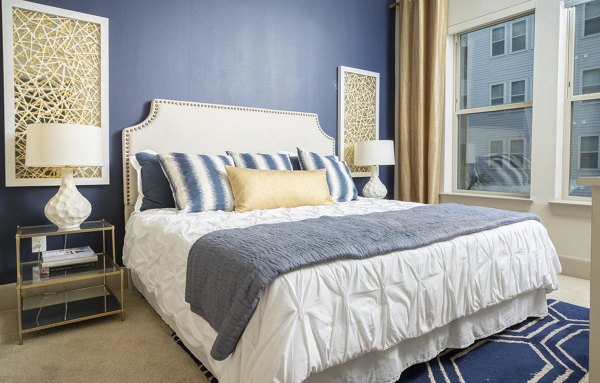 Elegant bedroom with contemporary design at Regency Park Apartments, featuring a plush bed and natural light, showcasing luxury living