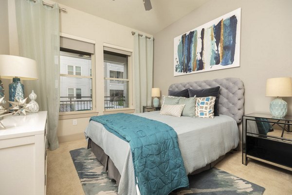 Elegant bedroom with natural light at Regency Park Apartments