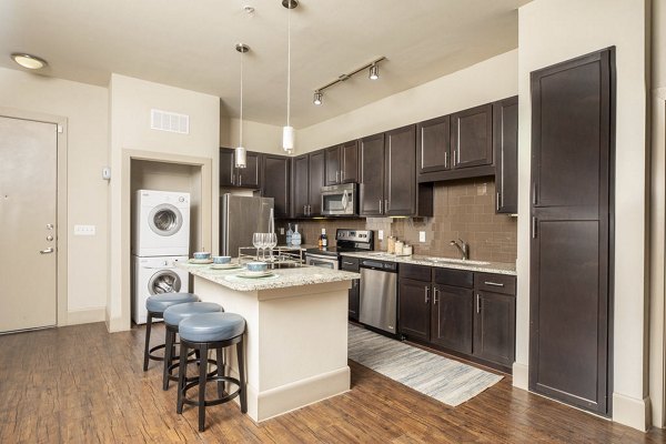 Sleek modern kitchen with stainless steel appliances at Regency Park Apartments, offering luxury living spaces