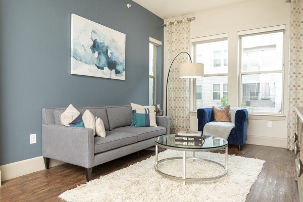 Spacious living room with modern decor in Regency Park Apartments, featuring comfortable seating and natural light