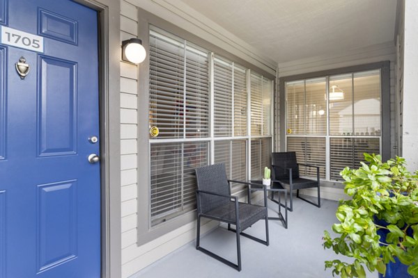 Cozy patio with lush greenery at Regency Park Apartments, perfect for outdoor relaxation and leisure activities in a serene environment