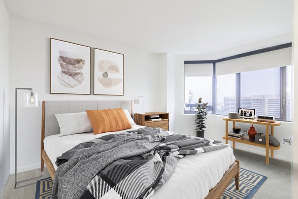 Cozy bedroom with modern decor at Marlowe Apartments featuring luxury finishes and ample natural light, ideal for comfortable urban living