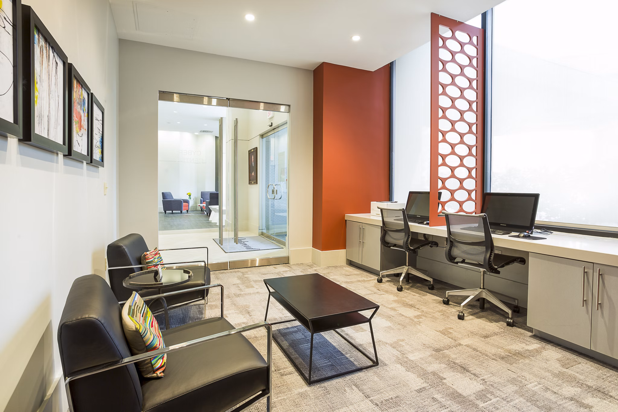 Modern business center at Marlowe Apartments featuring state-of-the-art workstations and sleek design