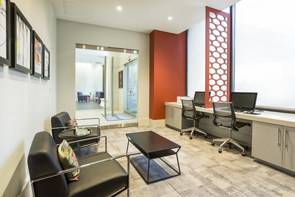 Modern business center at Marlowe Apartments featuring state-of-the-art workstations and sleek design