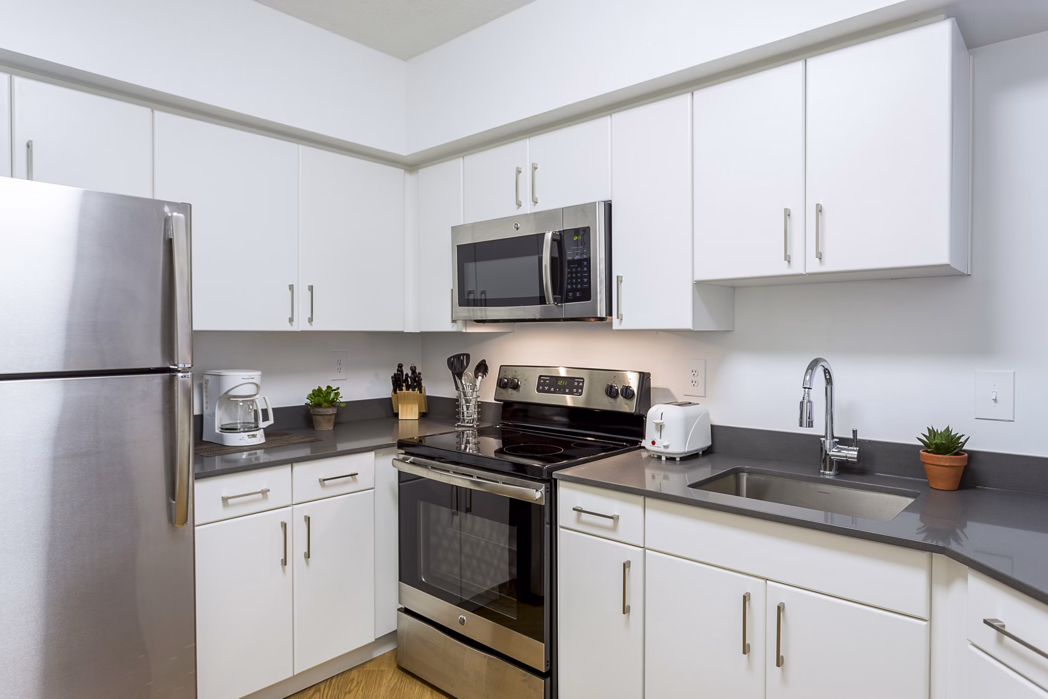 Modern kitchen with sleek cabinetry and stainless steel appliances at Marlowe Apartments