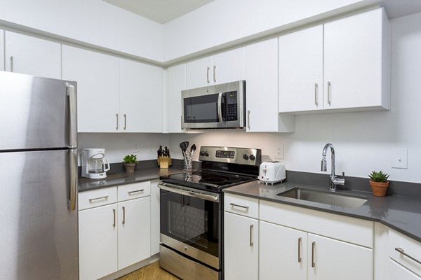 Modern kitchen with sleek cabinetry and stainless steel appliances at Marlowe Apartments