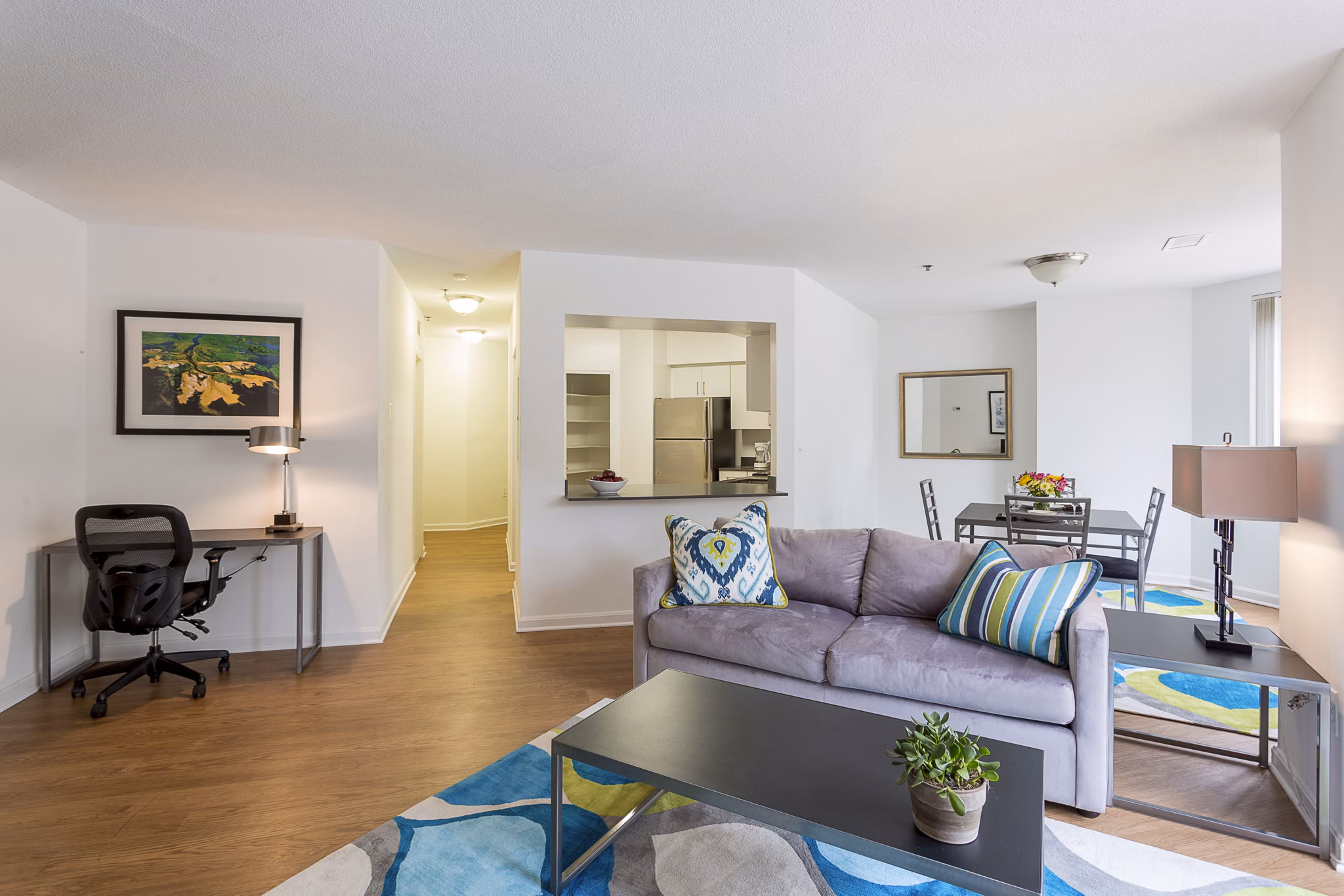 Spacious living room featuring modern furnishings and large windows in Marlowe Apartments