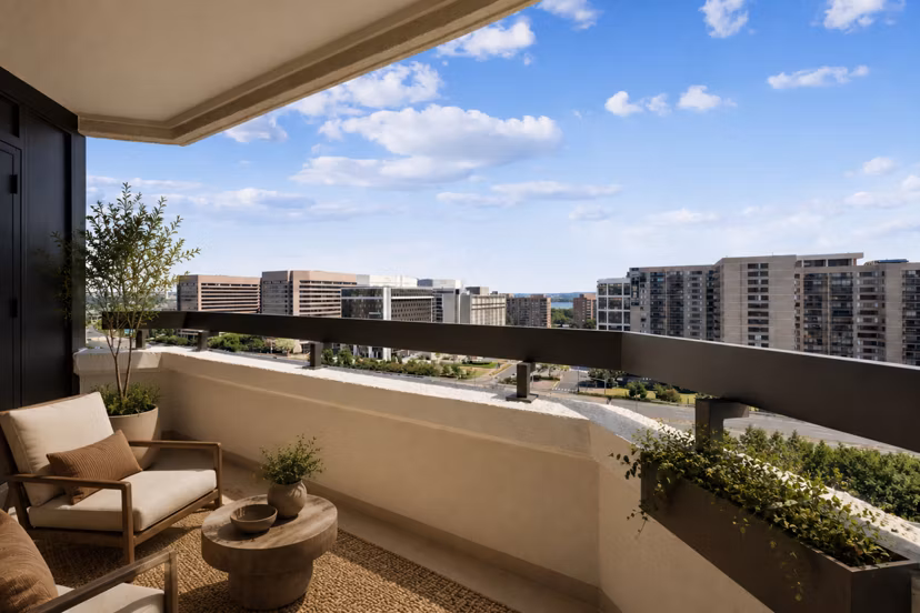 Marlowe Apartments: Private balcony with outdoor seating and city views, luxury living in a vibrant urban neighborhood