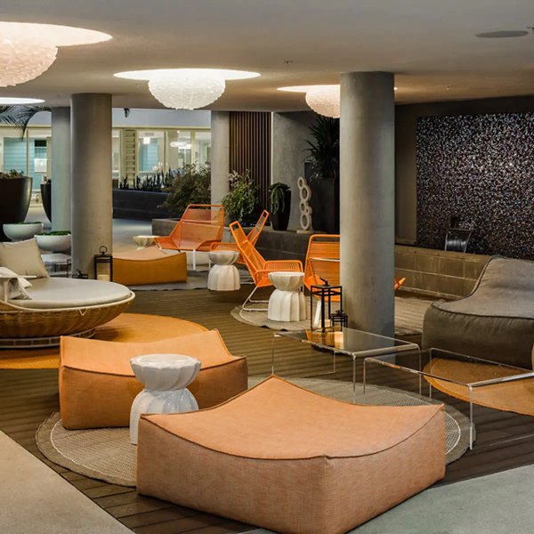 Stella Apartments: Inviting clubhouse with modern dÃ©cor and seating areas in luxury Greystar community