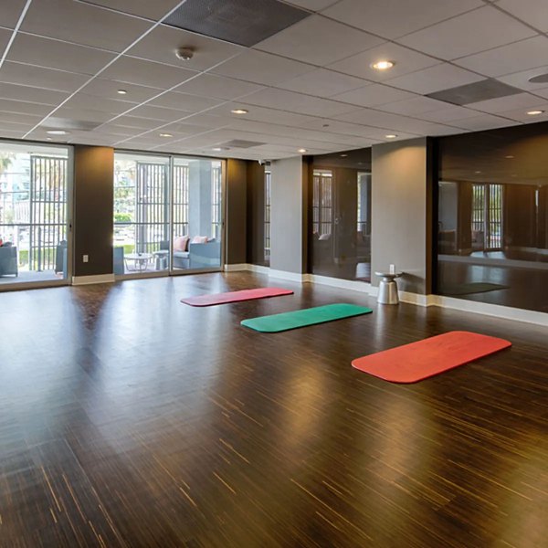 Yoga and spin studio at Stella Apartments with modern equipment and spacious layout for fitness enthusiasts