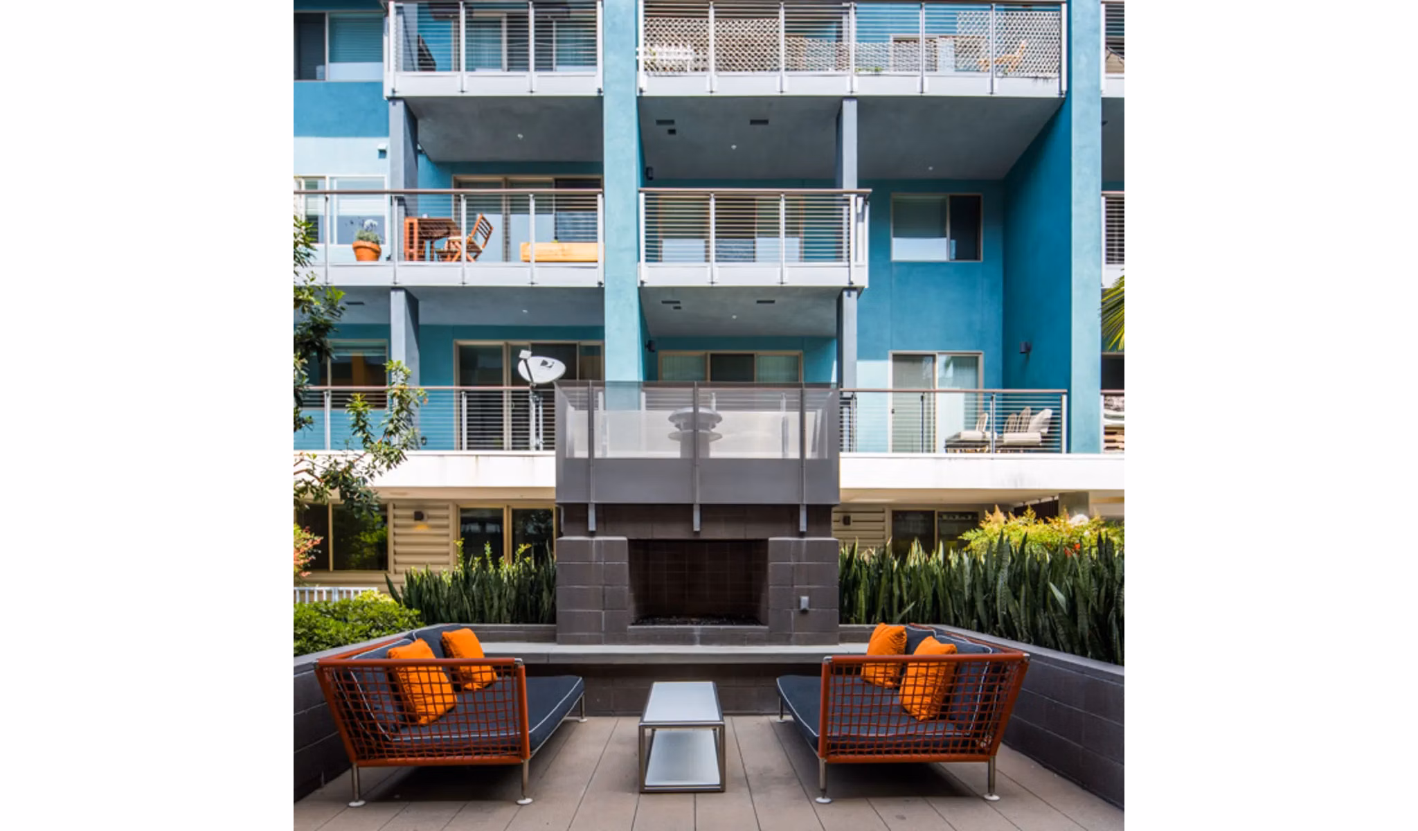Open-air courtyard with lush landscaping at Stella Apartments, a luxurious property offering relaxing outdoor spaces
