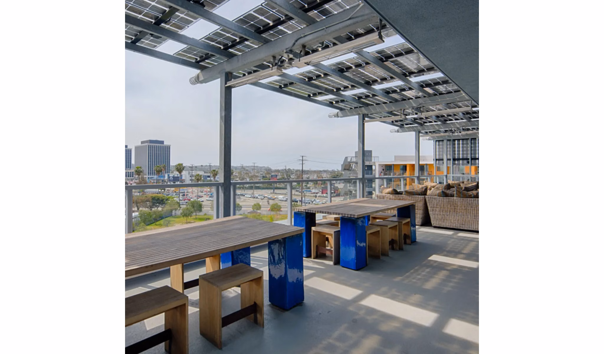 Rooftop deck at Stella Apartments: Luxurious cityscape views and seating area