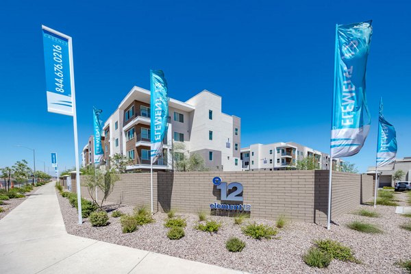 Element 12 at Cadence Apartments: Modern with prominent signage in vibrant urban setting