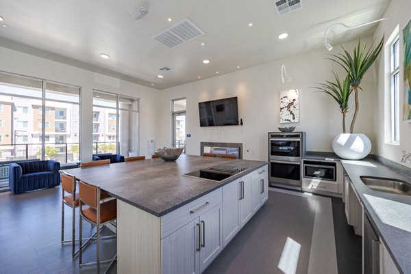 Modern clubhouse featuring lounge seating and billiard table in Element 12 at Cadence Apartments