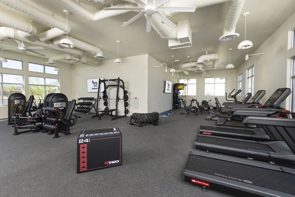 Fully-equipped fitness center at Element 12 at Cadence Apartments with state-of-the-art exercise machines and free weights