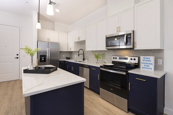 Modern kitchen with stainless steel appliances at Element 12 at Cadence Apartments