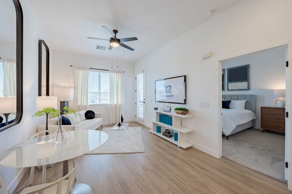 Spacious living room with modern decor in Element 12 at Cadence Apartments
