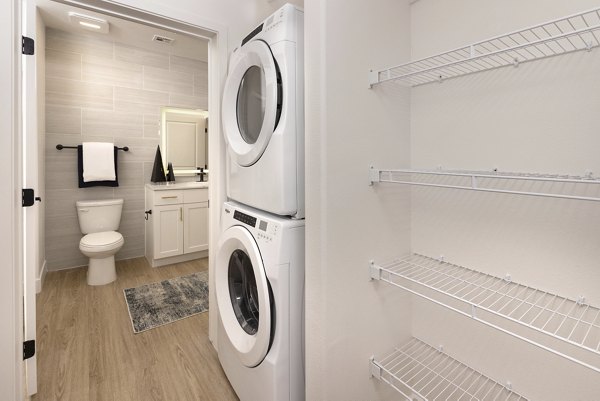 Laundry room with modern appliances at Element 12 at Cadence Apartments