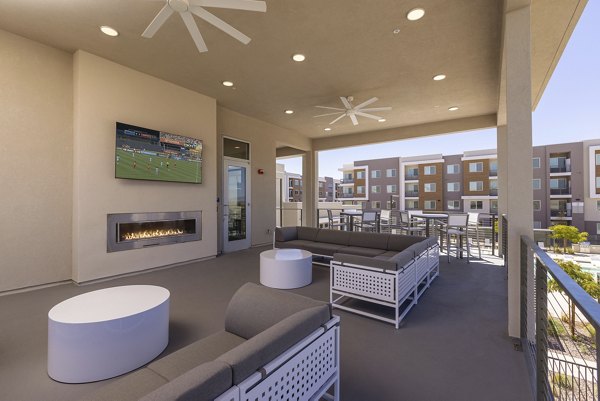 Cozy fire pit patio at Element 12 at Cadence Apartments, perfect for relaxation and social gatherings in a luxury setting