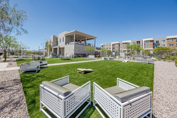 Modern recreational area with patio seating and lush greenery at Element 12 at Cadence Apartments for relaxation and socializing