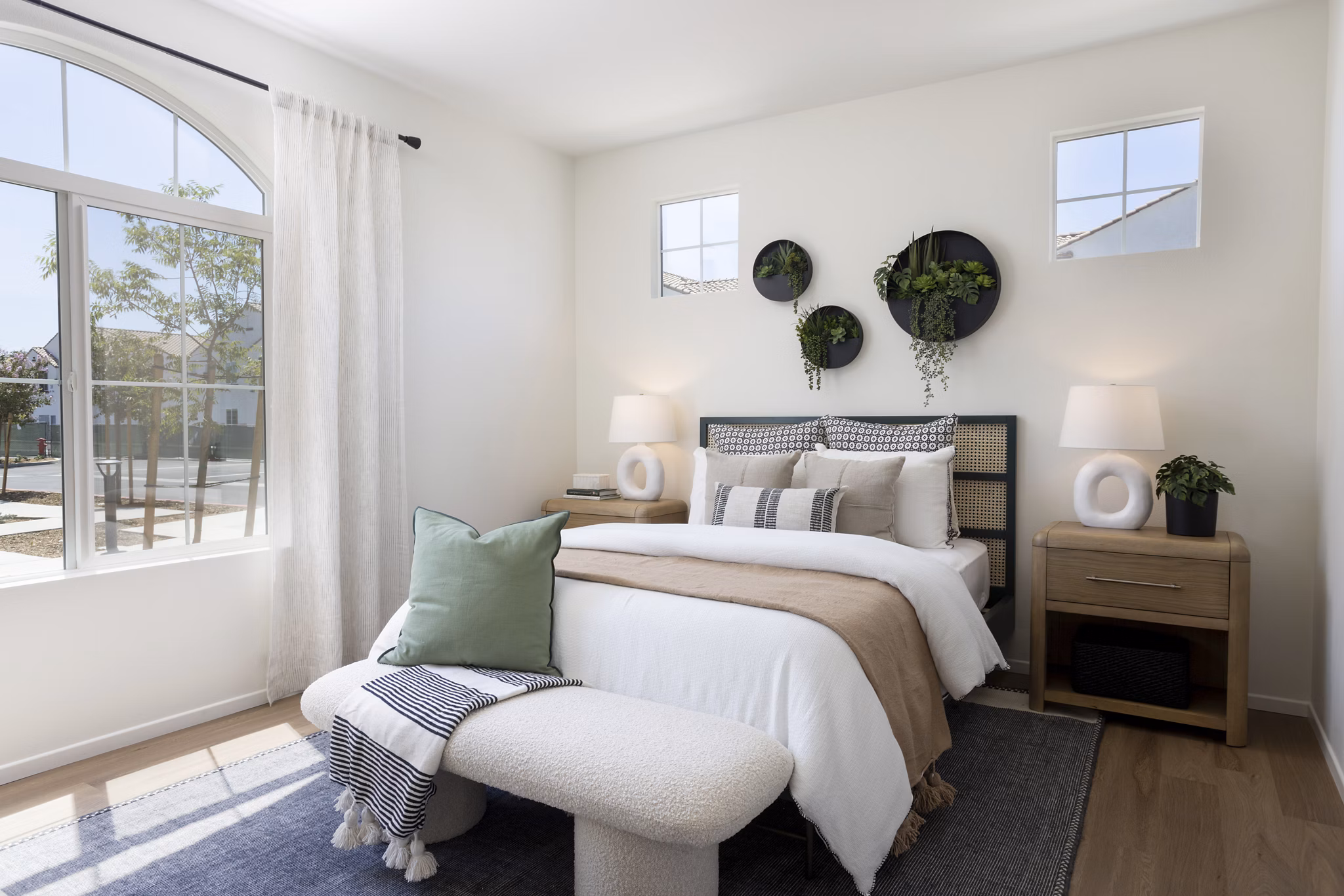 Modern bedroom featuring a stylish bed and wall-mounted planters in luxury apartments