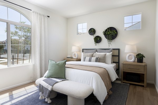 Modern bedroom featuring a stylish bed and wall-mounted planters in luxury apartments