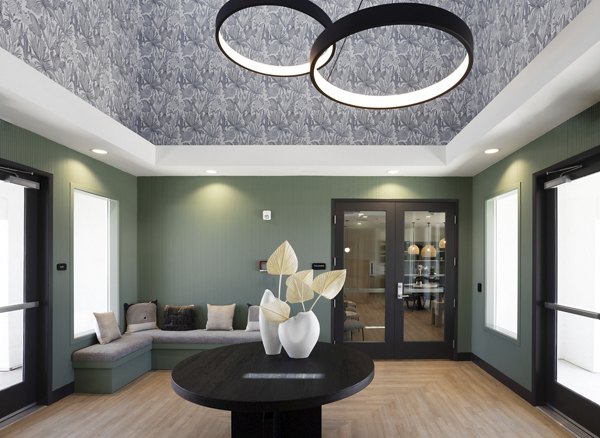 Modern dining area with a round table and decorative vases in luxury apartments