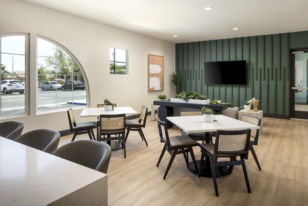 Spacious meeting room with modern furniture and a TV in luxury apartments
