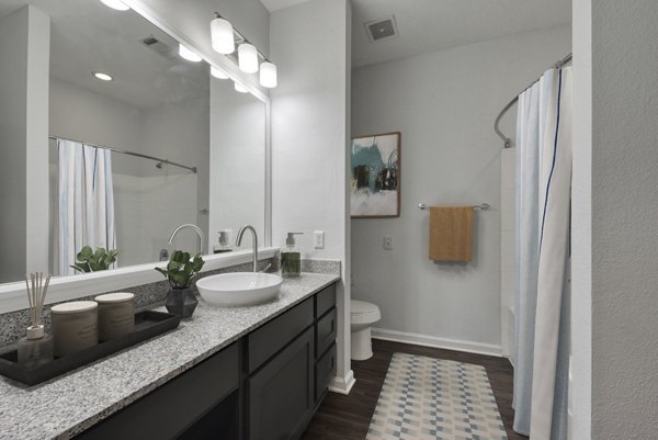 Modern bathroom with marble countertops at The Jax Apartments