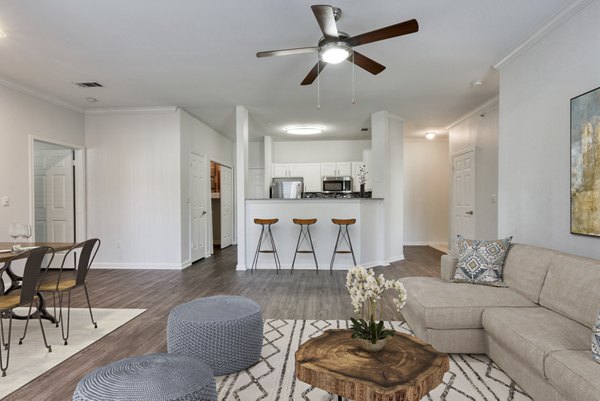 Spacious living room with modern decor at The Jax Apartments, featuring luxury finishes and ample natural light