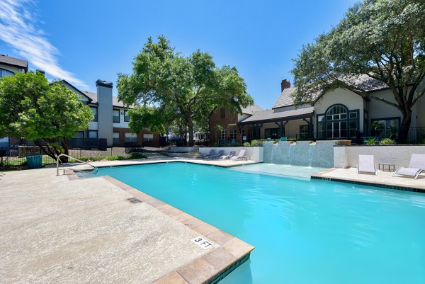 Rooftop pool with lounge chairs at The Jax Apartments in luxury setting