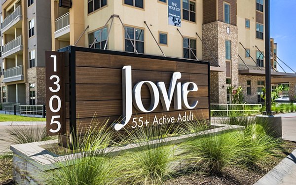 Signage at Jovie Pflugerville Apartments displaying the property's name and branding elements in a modern font style