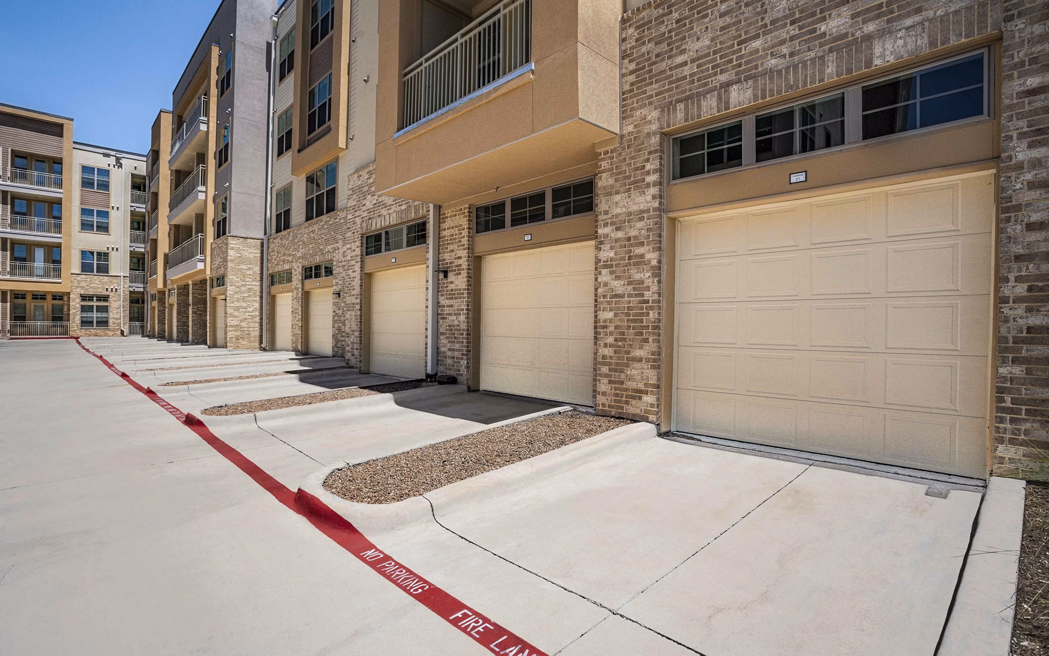 Spacious parking garage with ample lighting at Jovie Pflugerville Apartments