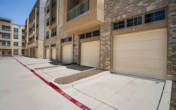 Spacious parking garage with ample lighting at Jovie Pflugerville Apartments