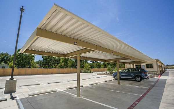 Covered parking facilities at Jovie Pflugerville Apartments offer convenient and protected vehicle storage in a well-maintained Greystar property